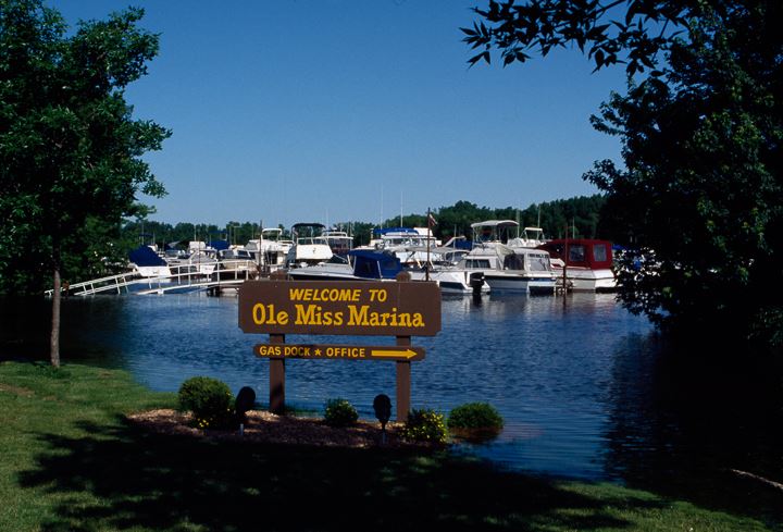 Boats in water behind Ole Miss Marina sign