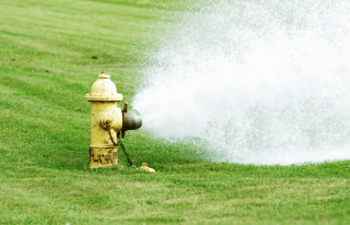 Water spraying from yellow fire hydrant