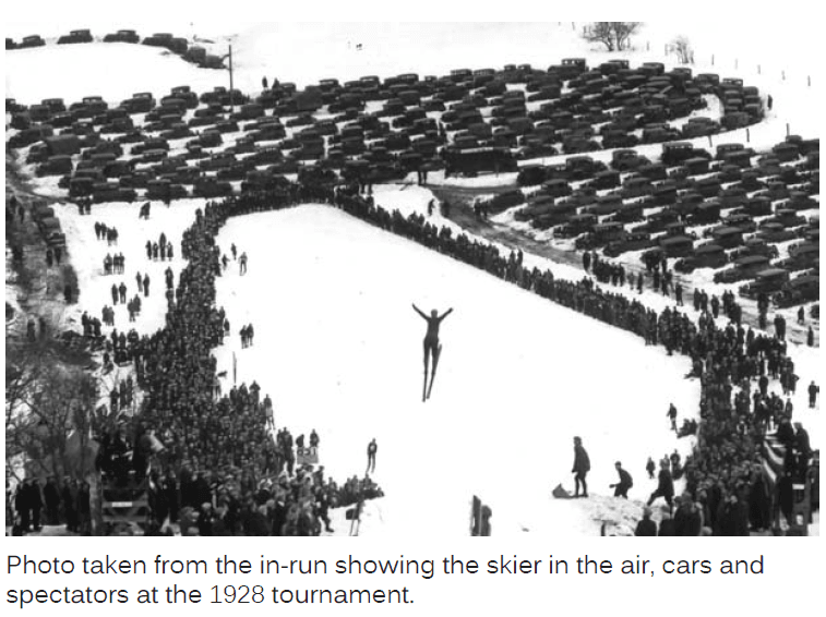 Photo Taken from the in-Run Showing the Skier in the Air, Cars and Spectators at the 1928 Tournament