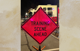 Training Scene Ahead sign with fire engine in background